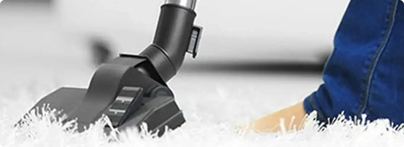 Close-up of a professional vacuuming a white carpet in Seminole.